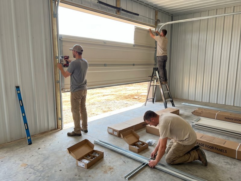 New sectional garage door being fitted in a garage